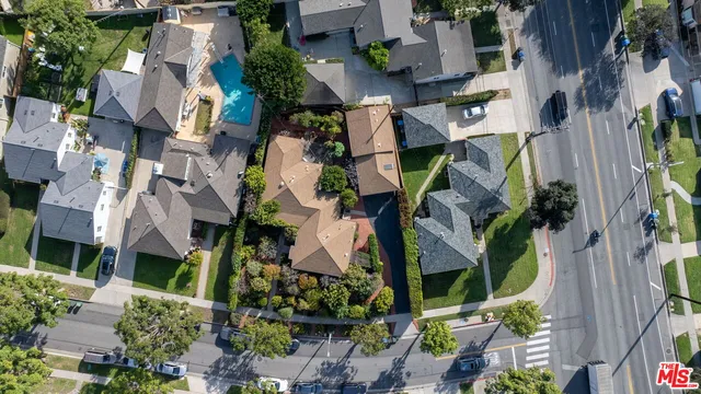 an aerial view of house with yard and mountain view in back