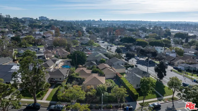 an aerial view of residential house with outdoor space and swimming pool
