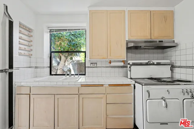 a kitchen with appliances cabinets and a sink
