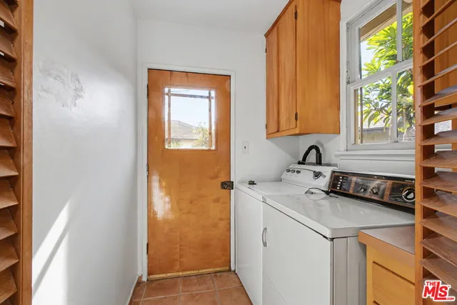 a view of a kitchen with a sink and cabinets