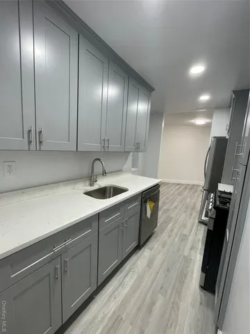 a kitchen with stainless steel appliances a sink stove and cabinets