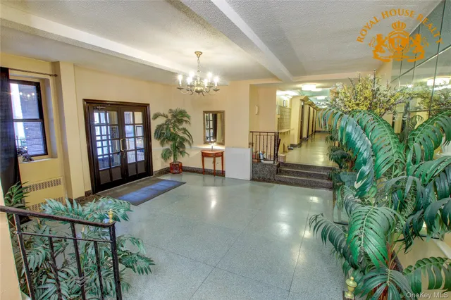 a lobby with furniture and chandelier