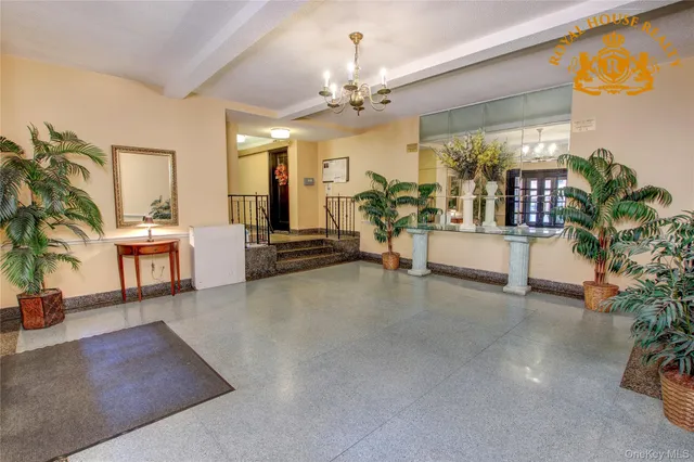 a living room with furniture and potted plants