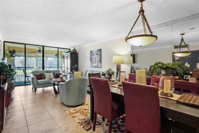 a living room with furniture a chandelier and a window