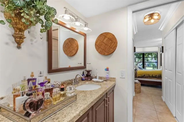 a bathroom with a granite countertop sink and a mirror