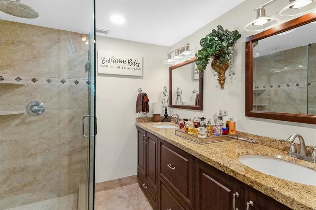 a bathroom with a granite countertop sink mirror and double