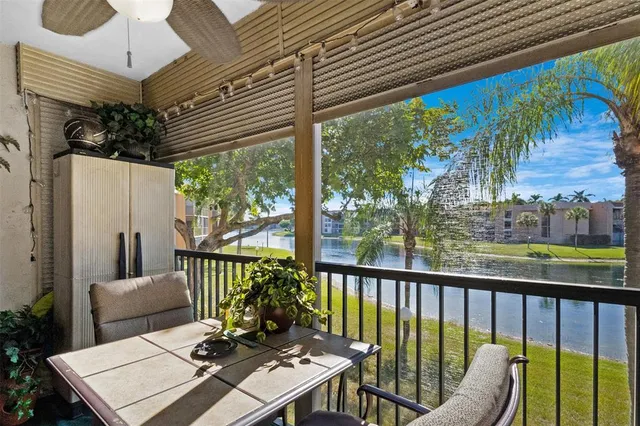 a view of a balcony with chairs and a table
