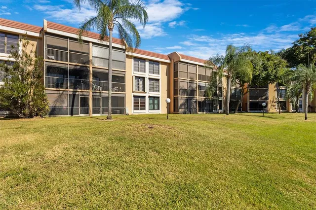 a front view of a building with a garden