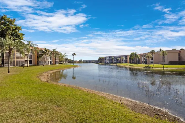 a view of a lake with houses in the background