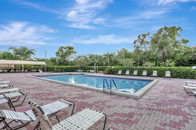 a view of swimming pool with seating space
