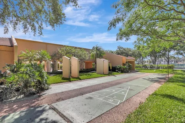 a room with pool table and windows