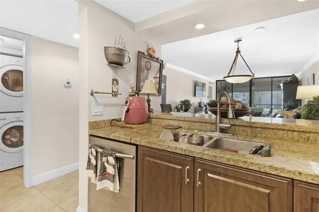 a kitchen with a sink a stove and cabinets