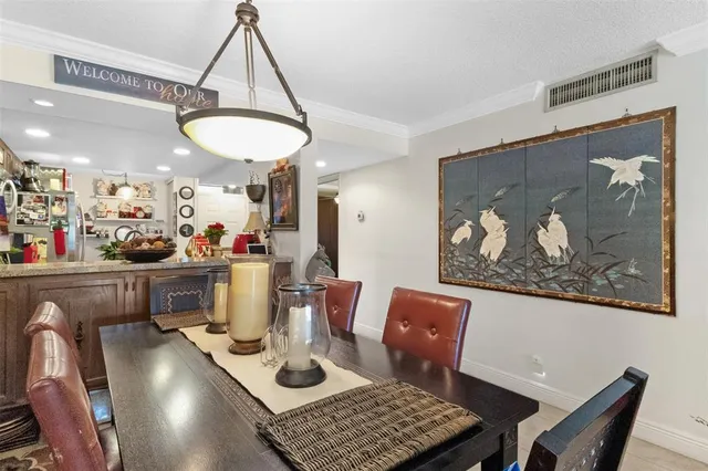 a view of a dining room with furniture and chandelier