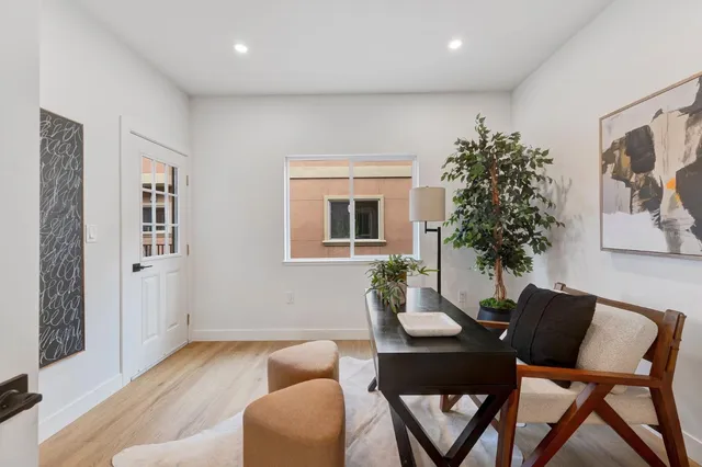 a living room with furniture potted plant and a window
