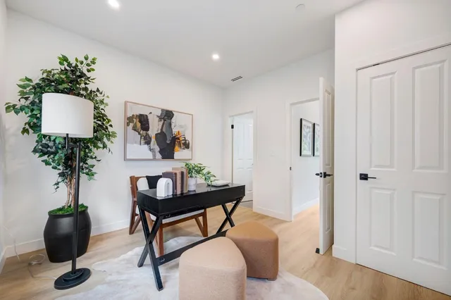 a living room with furniture and potted plant