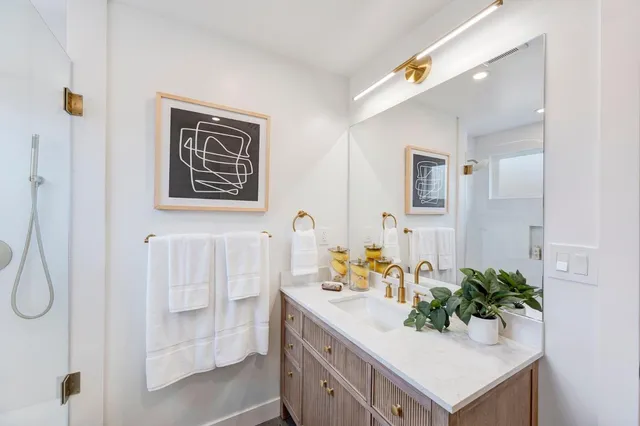 a bathroom with a sink mirror and vanity