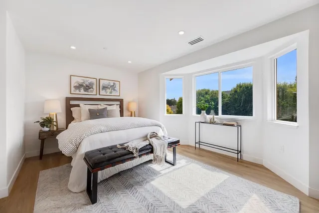 a bed room with a bed and a chair