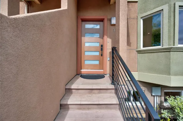 a view of staircase with wooden floor and black wall