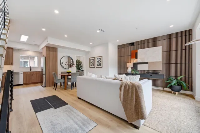 a living room with furniture a fireplace and gym equipment