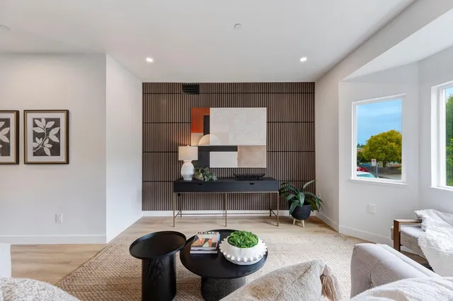 a living room with furniture and a potted plant