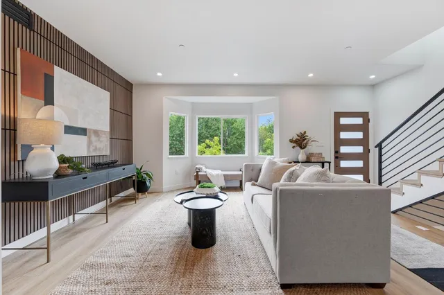 a living room with furniture a window and a table