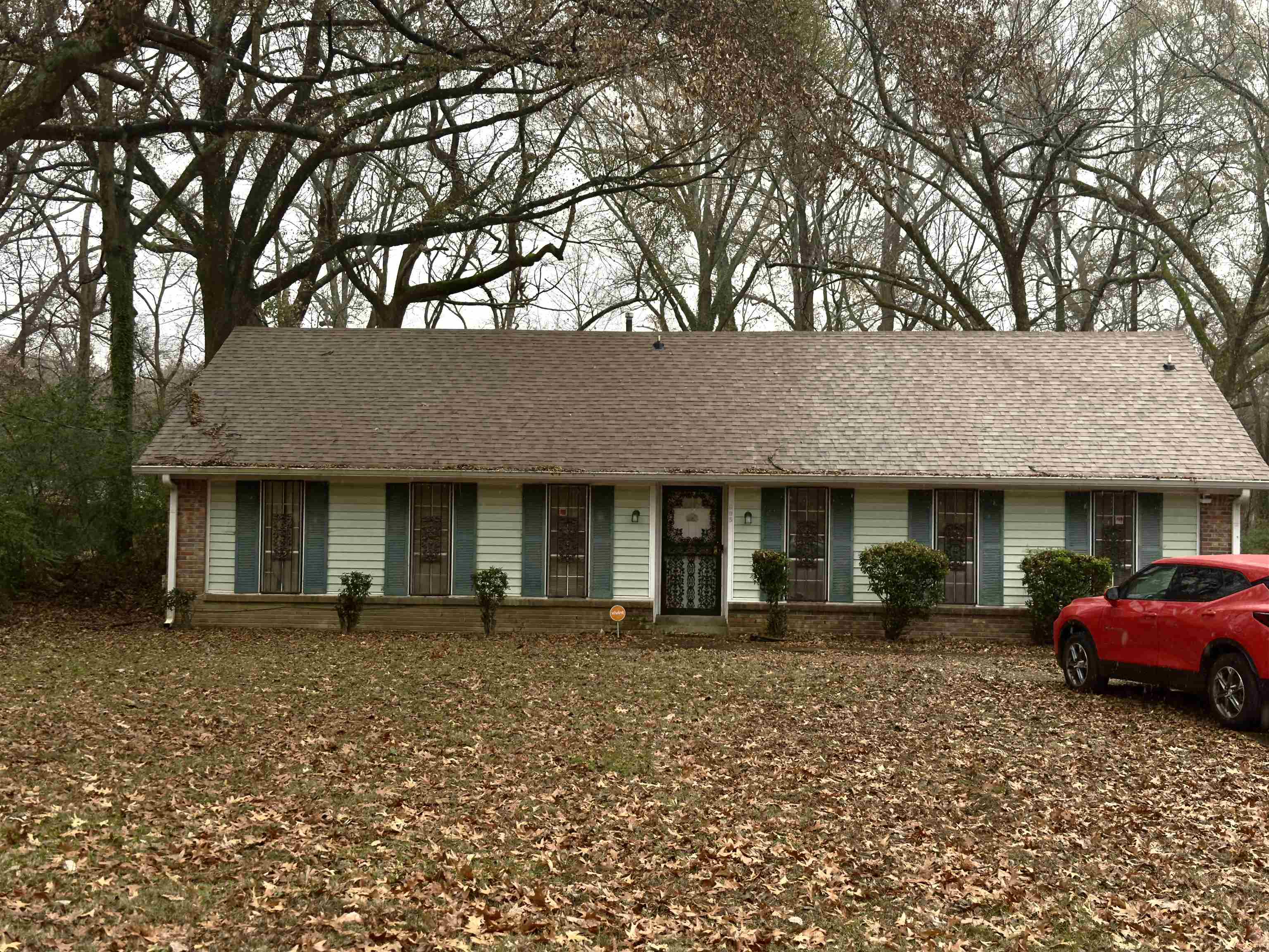 Ranch-style house featuring roof with shingles