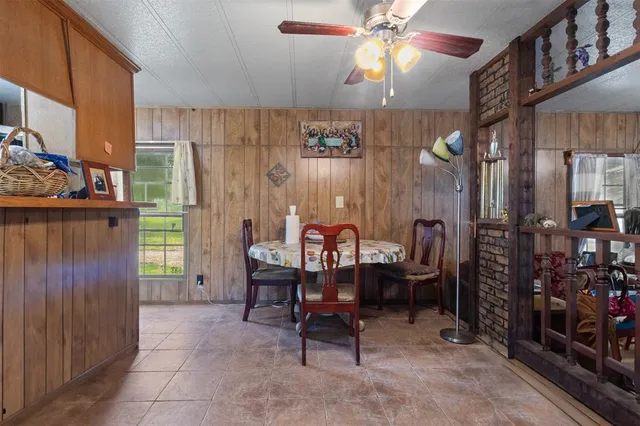 a dining room with furniture and a window