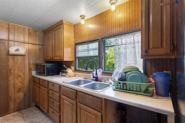 a kitchen with a sink cabinets and window