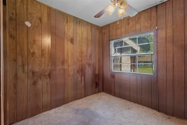 a view of wooden door and chandelier fan