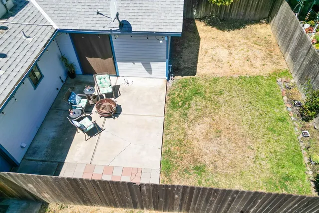 a vase of flowers sitting on a table next to a road