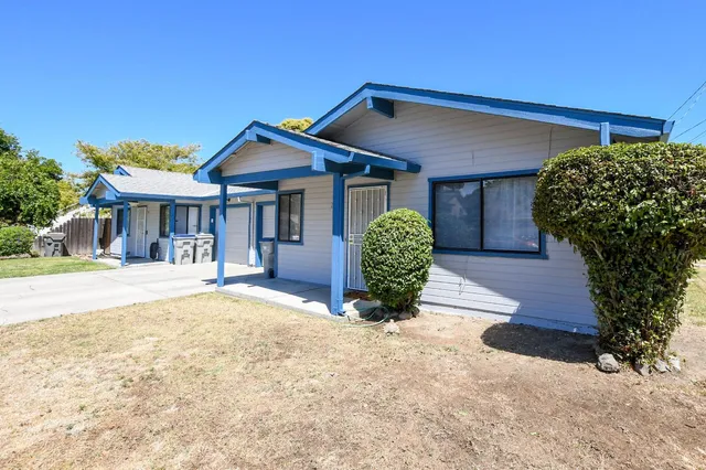 a front view of a house with garden