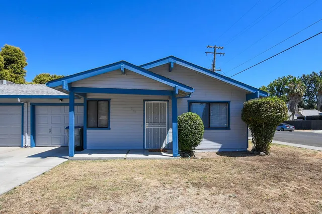 a front view of a house with garden
