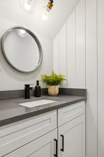 a bathroom with a double vanity sink mirror and