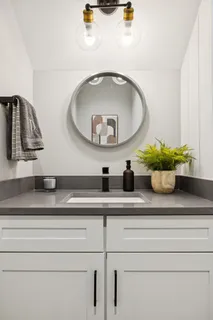 a en suite bathroom with a double vanity sink a mirror and a