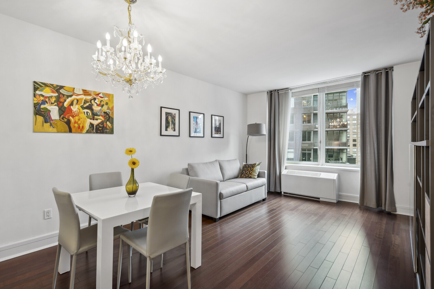 60 Riverside Boulevard, Unit 1806 Manhattan, NY 10069 - Photo 1 of 16 a living room with furniture and a chandelier