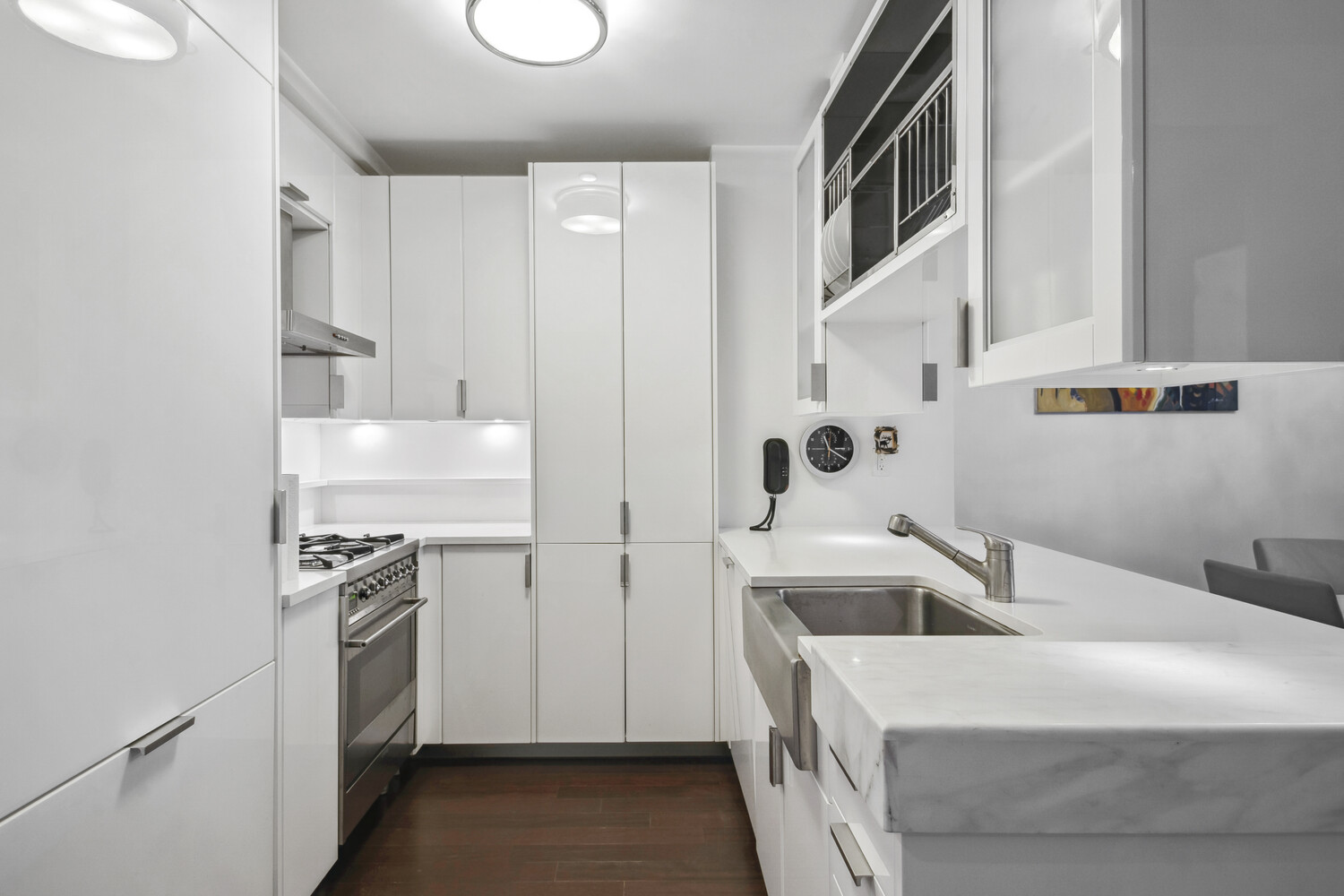 60 Riverside Boulevard, Unit 1806 Manhattan, NY 10069 - Photo 4 of 16 a kitchen with a sink stove and cabinets