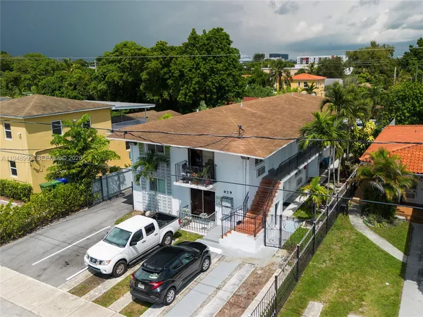 an aerial view of multiple houses with yard