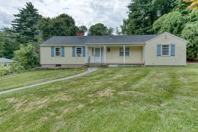 a view of a house with a backyard