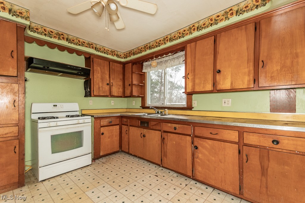 3303 River Road Perry, OH 44081 - Photo 20 of 34 Kitchen with ventilation hood, sink, ceiling fan, and white gas range oven