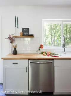 a sink with a window and cabinets