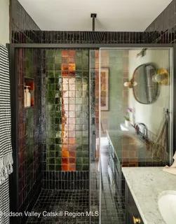 a bathroom with a granite countertop shower a mirror and a sink