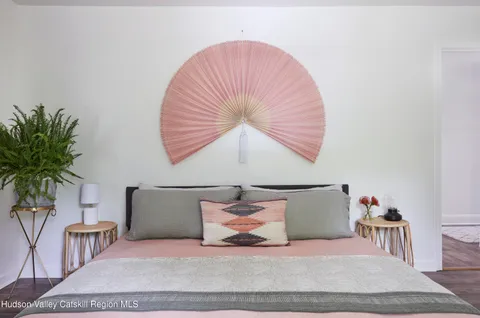 a bedroom with a bed and a potted plant