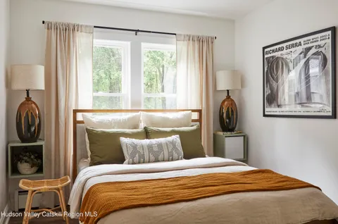 a bedroom with a bed and a painting on the wall