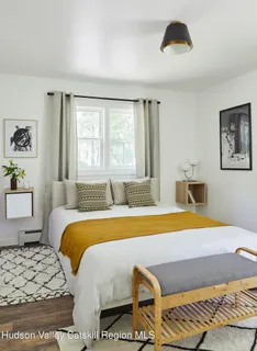 a bedroom with a bed and a couch