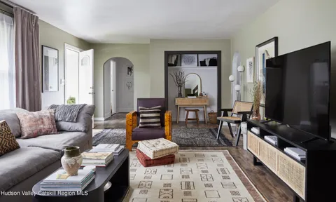 a living room with furniture fireplace and a flat screen tv
