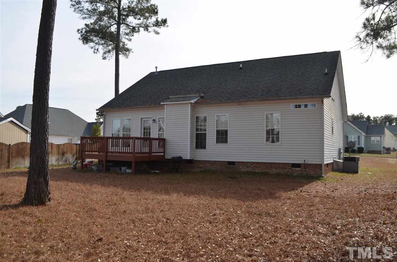7137 Spanglers Spring Way Raleigh, NC 27610 - Photo 7 of 8 a view of a house with a backyard