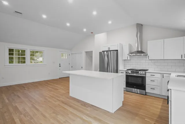 a kitchen with stainless steel appliances a refrigerator sink and stove