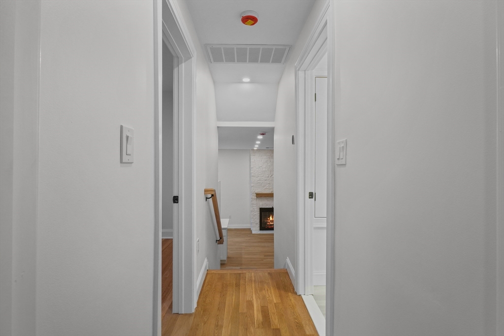 217 Central Street Framingham, MA 01701 - Photo 15 of 42 a view of a hallway with wooden floor and a bathroom