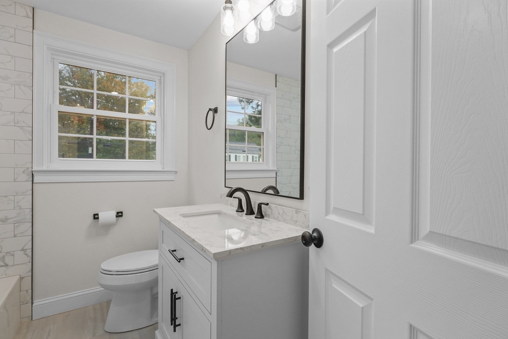217 Central Street Framingham, MA 01701 - Photo 25 of 42 a bathroom with a toilet a sink a mirror and shower