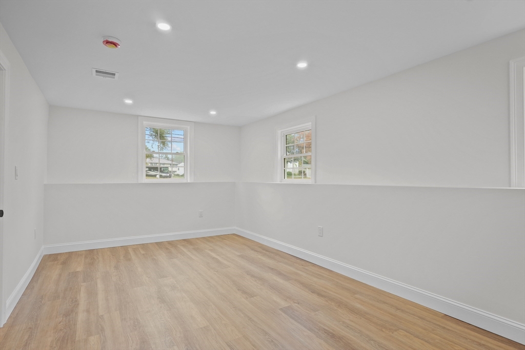 217 Central Street Framingham, MA 01701 - Photo 28 of 42 a view of empty room with wooden floor and fan
